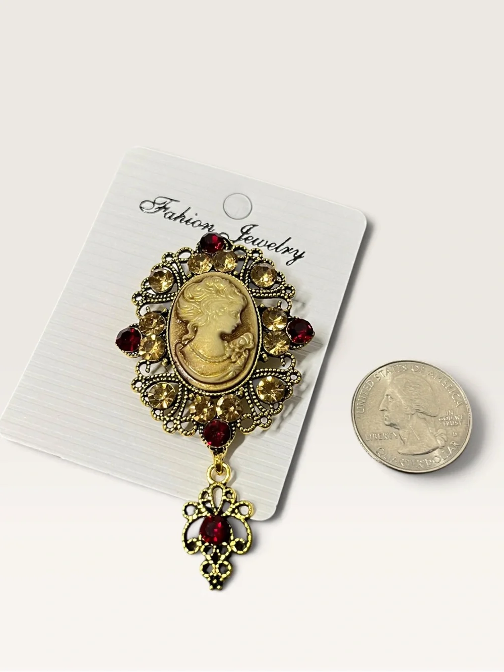 Vintage-Inspired Gold Cameo Brooch with Red and Champagne Stones